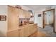Kitchen area featuring wood cabinets, laminate countertops, and views to the hallway at 12663 S Silver Creek Ct, Parker, CO 80134