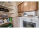 Functional laundry room featuring modern washer and dryer units, built-in shelving, and cabinet space at 12663 S Silver Creek Ct, Parker, CO 80134