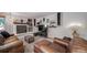 Comfortable living room featuring a stone fireplace, decorative shelving, plush seating, and ambient lighting at 12663 S Silver Creek Ct, Parker, CO 80134