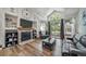 Spacious living room with stone fireplace, large windows and sliding door to the backyard at 12663 S Silver Creek Ct, Parker, CO 80134