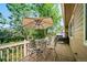 Outdoor patio area with a table, chairs, sun umbrella, and views of the surrounding greenery at 12663 S Silver Creek Ct, Parker, CO 80134