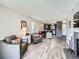 Open concept living room leading into the kitchen, with wood floors and comfortable seating at 2740 W 86Th Ave # 178, Westminster, CO 80031