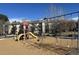 Community playground with swings, slides, and play structures, near apartment buildings at 2740 W 86Th Ave # 178, Westminster, CO 80031