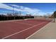 Outdoor tennis court with net, surrounded by a fence and landscaping at 2740 W 86Th Ave # 178, Westminster, CO 80031