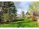 Sprawling backyard, lush green lawn, and verdant foliage at 6385 S Jay Way, Littleton, CO 80123