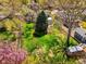 Large grassy backyard with mature trees, a fence, and a glimpse of the house at 6385 S Jay Way, Littleton, CO 80123