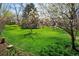 A lovely green and spacious backyard with grass and a few trees at 6385 S Jay Way, Littleton, CO 80123