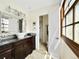 Bright bathroom featuring granite counters, a vessel sink, and natural light from a window at 6385 S Jay Way, Littleton, CO 80123