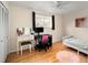 Cozy bedroom with a vanity, chair, bed and pink rug on a light hardwood floor at 6385 S Jay Way, Littleton, CO 80123