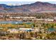 Panoramic city view featuring a lake, mountains, buildings and lush trees at 6385 S Jay Way, Littleton, CO 80123
