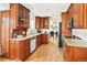 A charming kitchen features wooden cabinets, granite countertops, and stainless steel appliances at 6385 S Jay Way, Littleton, CO 80123