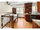 Eat-in kitchen featuring wood cabinets, granite counters, stainless steel appliances, and an adjacent dining area at 6385 S Jay Way, Littleton, CO 80123
