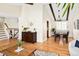 Open concept living space with exposed beams and dining area with hardwood floors at 6385 S Jay Way, Littleton, CO 80123