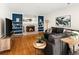 Living room features a brick fireplace, built-in shelving, hardwood floors, and large windows at 6385 S Jay Way, Littleton, CO 80123