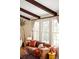 Inviting living area with exposed beams, leather sofa, large windows and stylish decor at 6385 S Jay Way, Littleton, CO 80123