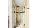 Walk-in shower with glass door and decorative stone tile at 6385 S Jay Way, Littleton, CO 80123