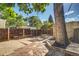 Relax in this backyard with a stone patio, wooden fence and mature trees at 575 N Marion St, Denver, CO 80218