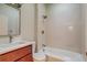Cozy bathroom with vanity, a tiled shower-tub combo, decorative lighting and neutral wall paint at 575 N Marion St, Denver, CO 80218