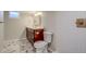 Bathroom featuring dark vanity, marble flooring and shower walls, with gold accents and recessed lighting at 575 N Marion St, Denver, CO 80218