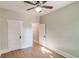 Bedroom with light walls, laminate flooring, ceiling fan, and doorway leading to an adjacent room at 575 N Marion St, Denver, CO 80218