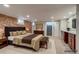 Spacious bedroom features an exposed brick wall, and a seating area with vanity at 575 N Marion St, Denver, CO 80218