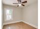 Bedroom featuring light walls, laminate flooring, ceiling fan and a large window for ample sunlight at 575 N Marion St, Denver, CO 80218