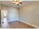 Neutral bedroom featuring light walls, light laminate flooring, a closet, ceiling fan and view of the doorway at 575 N Marion St, Denver, CO 80218