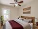Bedroom featuring neutral tones, wood furnishings, large window, ceiling fan and stylish décor at 575 N Marion St, Denver, CO 80218