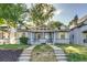 Inviting home exterior with manicured lawn, steps, and mature trees, creating a warm welcome at 575 N Marion St, Denver, CO 80218
