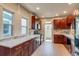 Stylish kitchen with dark wood cabinets, marble countertops, and stainless steel appliances at 575 N Marion St, Denver, CO 80218