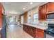 Large kitchen with dark wood cabinets, marble countertops with an open connection to the living room at 575 N Marion St, Denver, CO 80218