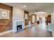 Open-concept living room with exposed brick and a modern fireplace with a kitchen view at 575 N Marion St, Denver, CO 80218
