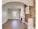 Bright living room features exposed brick, white trim, a fireplace, and an open design at 575 N Marion St, Denver, CO 80218