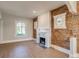 Living room with exposed brick, fireplace and original windows offering a warm, inviting space at 575 N Marion St, Denver, CO 80218
