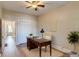 Bright home office with a ceiling fan, wood desk, area rug and a view of a doorway to the next room at 575 N Marion St, Denver, CO 80218