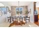 Stylish dining room with brick accent wall, chandelier, and a hide-print rug at 10935 Acadia, Parker, CO 80138