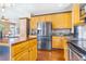 Well-lit kitchen with wood cabinets and stainless steel appliances at 10935 Acadia, Parker, CO 80138