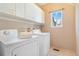 Bright laundry room with storage cabinets and a window at 10935 Acadia, Parker, CO 80138