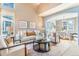 Open concept living room with lots of light and a dining room table in the background at 10935 Acadia, Parker, CO 80138