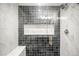 Elegant shower featuring black and white tiles, a glass door, and a marble bench at 357 S Franklin St, Denver, CO 80209