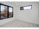 Minimalist bedroom with carpet floors and two large windows, with natural light, and neutral walls at 357 S Franklin St, Denver, CO 80209