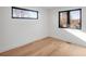 Empty bedroom with hardwood floors, white walls, and windows with views of the neighborhood at 357 S Franklin St, Denver, CO 80209