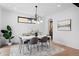 Dining area featuring a modern chandelier, large windows, and views into the kitchen at 357 S Franklin St, Denver, CO 80209