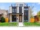 Modern home featuring a white brick facade, black trim, minimalist design, and well-manicured front lawn at 357 S Franklin St, Denver, CO 80209