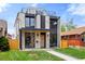 Modern two-story home with white brick, black accents, rooftop deck, and a well-maintained lawn at 357 S Franklin St, Denver, CO 80209