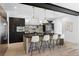 Stylish kitchen featuring a center island with seating, pendant lights, and contrasting dark wood cabinets at 357 S Franklin St, Denver, CO 80209