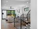 Living room and staircase with decorative drop lighting, modern railings and neutral decor at 357 S Franklin St, Denver, CO 80209