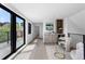 Bright open-concept living space with hardwood floors, a wet bar, black framed windows and a sliding door to a balcony at 357 S Franklin St, Denver, CO 80209