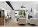 Bright, open living room features a fireplace, sliding glass doors, and eat-in kitchen island at 357 S Franklin St, Denver, CO 80209