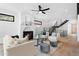 Modern living room with a fireplace, neutral furniture, hardwood floors, and a staircase at 357 S Franklin St, Denver, CO 80209